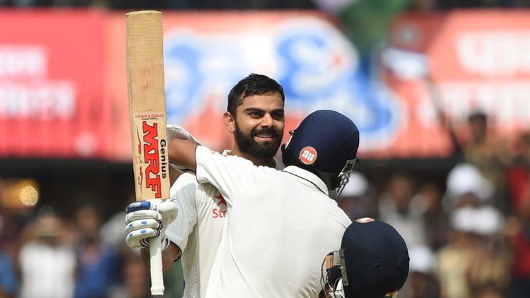 India's batsman and captain Virat Kohli (L) celebrates with a teammate Ajinkya Rahane after scoring a double century during the second day of third test cr