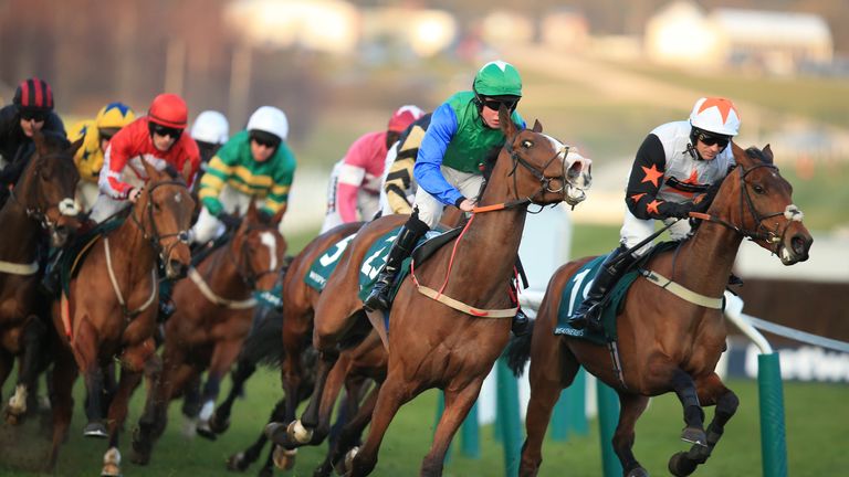 Winsome Bucks ridden by D L Queally (centre) and Spirit Of Kayf ridden by Danny Cook (right) in action during the Weatherbys Champion Bumper during Ladies 