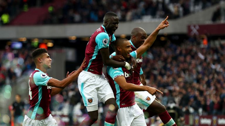 LONDON, ENGLAND - OCTOBER 22:  Winston Reid (R) of West Ham United celebrates scoring his team's first goal during the Premier League match between West Ha