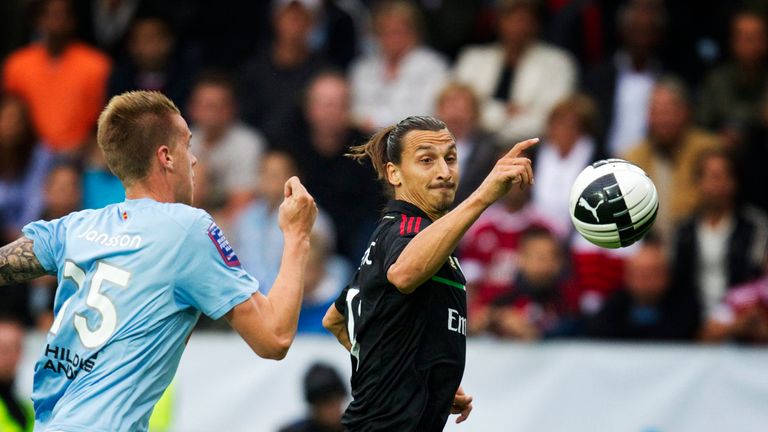 Malmo's Pontus Jansson runs after AC Milan's Zlatan Ibrahimovic during their friendly football match at the Swedbank Stadium in Malmo on August 14, 2011. A