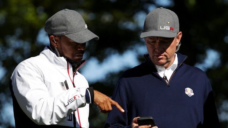 CHASKA, MN - SEPTEMBER 30:  Vice-captain Tiger Woods and captain Davis Love III of the United States talk during morning foursome matches of the 2016 Ryder