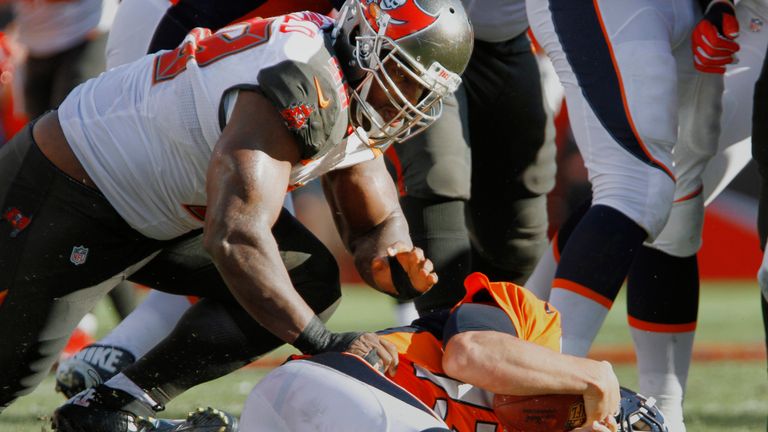 TAMPA, FL - OCTOBER 2:  Clinton McDonald #98 of the Tampa Bay Buccaneers slams Trevor Siemian #13 of the Denver Broncos for a sack late in the second quart