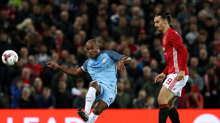 Vincent Kompany of Manchester City attempts a pass during the EFL Cup fourth round match between Manchester United as Zlatan Ibrahimovic looks on.