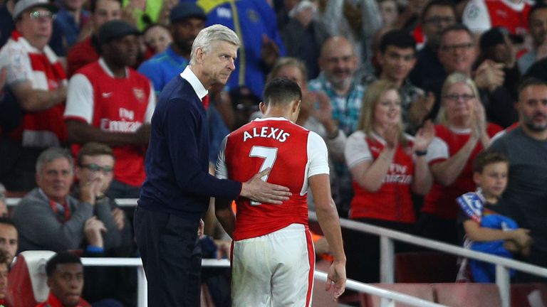 LONDON, ENGLAND - SEPTEMBER 24: Arsene Wenger, Manager of Arsenal pats Alexis Sanchez of Arsenal on the back after he is subbed during the Premier League m