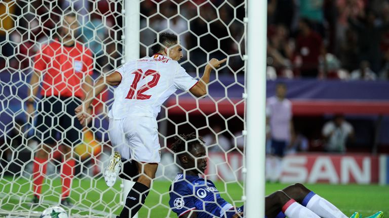 Sevilla's French forward Wissam Ben Yedder (L) celebrates a goal beside Lyon's defender Yanga-Mbiwa during the UEFA Champions League Group H football match