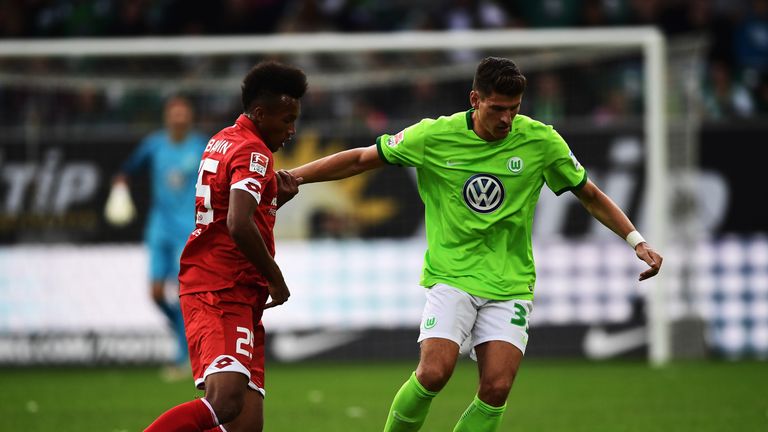of Wolfsburg is challenged by of Mainz during the Bundesliga match between VfL Wolfsburg and 1. FSV Mainz 05