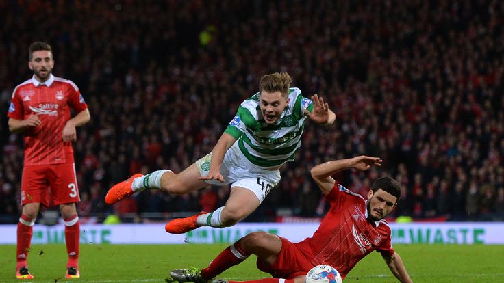 GLASGOW, SCOTLAND - NOVEMBER 27: James Forrest of Celtic is challenged in the penalty box by Anthony O'Conner of Aberdeen  resting in a penalty to Celtic d