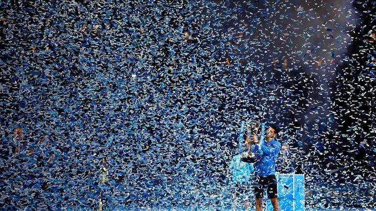 Novak Djokovic of Serbia lifts the trophy following his victory during the men's singles final against Roger Federer 
