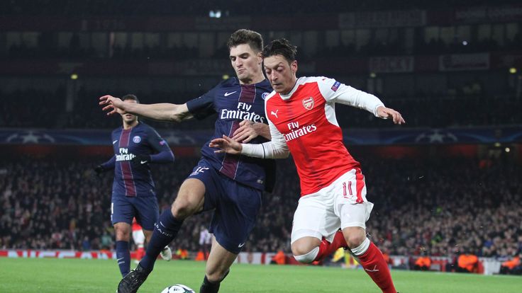 Arsenal's Mesut Ozil vies with Paris St Germain's Thomas Meunier