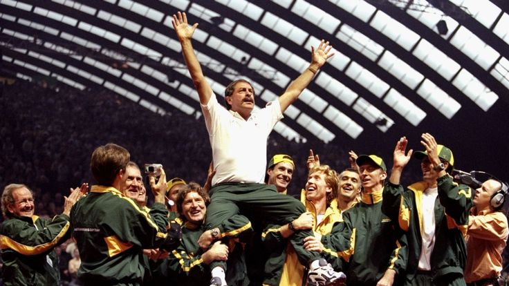 John Newcombe the Australian Captain is lifted in the air by the Australian team after winning the Davis Cup match against France