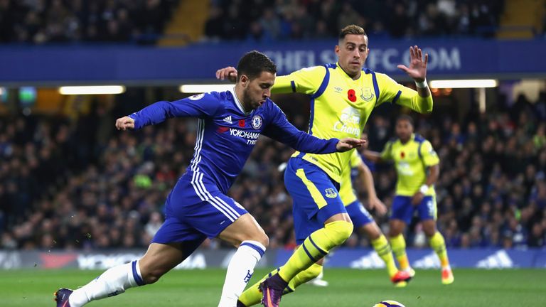 Eden Hazard of Chelsea (L) takes on Ramiro Funes Mori of Everton (R) during the Premier League match at Stamford Bridge