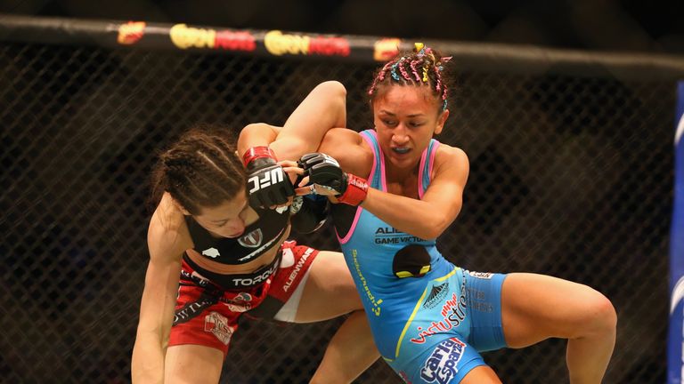 DALLAS, TX - MARCH 14:  (L-R) Joanna Jedrzejczyk fights with  Carla Esparza in the Women's Strawweight bout during the UFC 185 event at American Airlines C