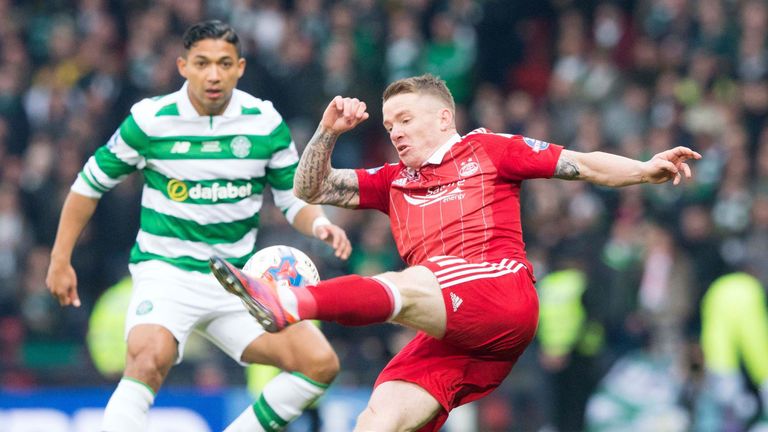 Jonny Hayes is watched by Emilio Izaguirre