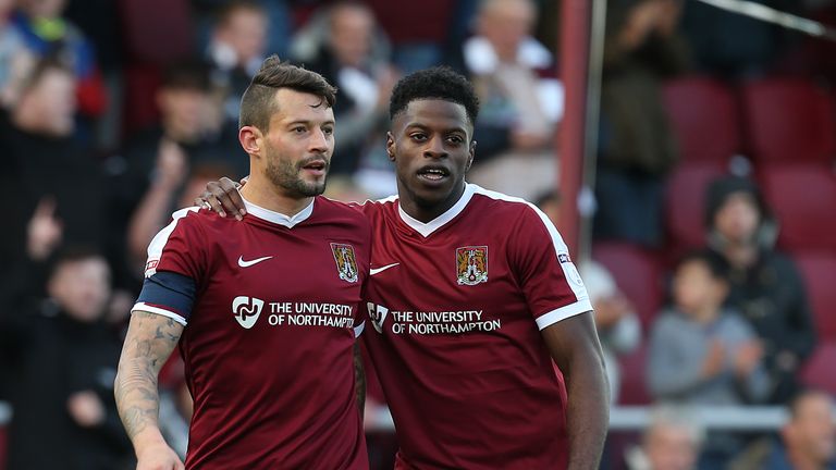 Marc Richards of Northampton Town celebrates with team-mate JJ Hooper after scoring his side's second goal v Harrow Borough in the FA Cup