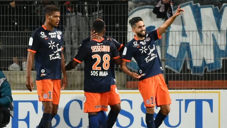 Montpellier's French midfielder Ryad Boudebouz (R) celebrates after scoring a goal during the French L1 football match between Montpellier and Marseille at