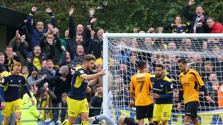 Oxford United's Alex MacDonald celebrates scoring his side's first goal during the Emirates FA Cup, First Round match v Merstham at Moatside, Merstham
