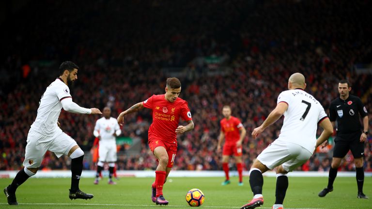 Miguel Britos of Watford and Nordin Amrabat of Watford close down Philippe Coutinho of Liverpool during the Premier League match at Anfield