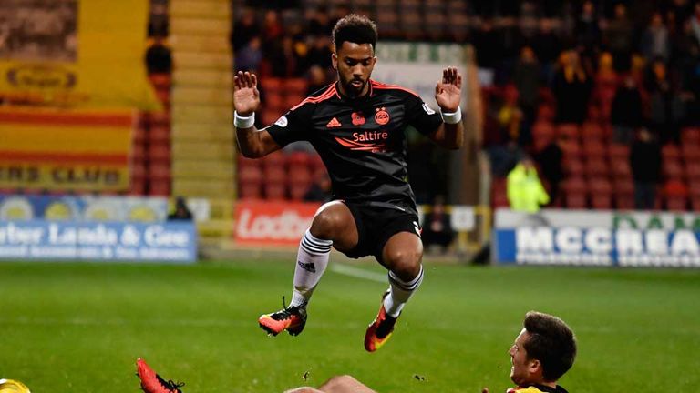 Aberdeen's Shay Logan hurdles a challenge from Callum Booth