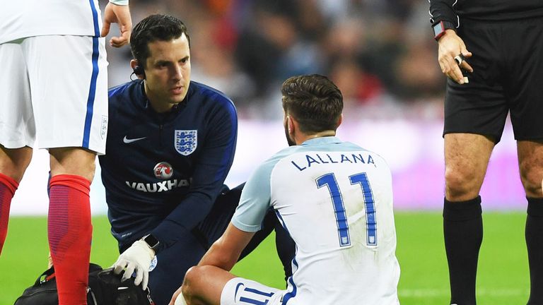 England midfielder Adam Lallana receives treatment at Wembley