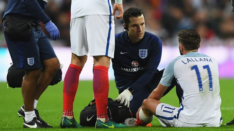 LONDON, ENGLAND - NOVEMBER 15: Adam Lallana of England receives medical attention after picking up an injury during the international friendly match betwee