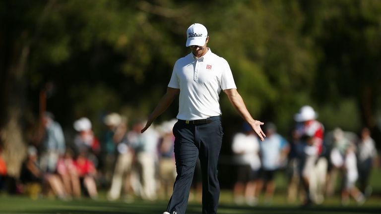Adam Scott of Australia reacts to his approach shot on the 18th hole during day one of the 2016 Australian Open 