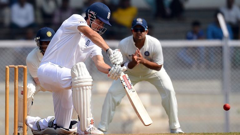 India 'A' cricketers Wriddhiman Saha (L) and Suesh Raina (R) watch as England cricketer Alastair Cook bats during the second day of a three day warm up mat
