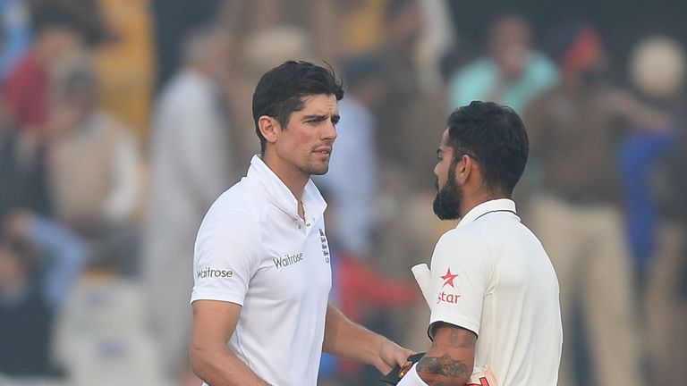 Indian batsman and captain Virat Kohli (R) shakes hands with England captain Alastair Cook after winning the third Test cricket match in Mohali