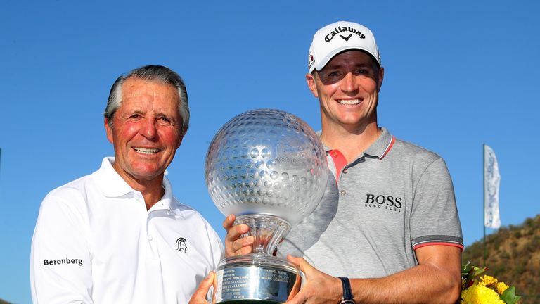 Alex Noren of Sweden receives the trophy from Gary Player after his victory during day four of the Nedbank Golf Challenge