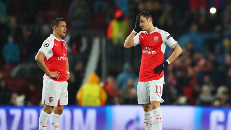 BARCELONA, SPAIN - MARCH 16: Alexis Sanchez (L) and Mesut Ozil (R) of Arsenal show their dejection after Barcelona's first goal during the UEFA Champions L