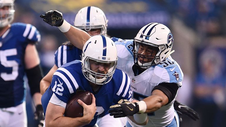 INDIANAPOLIS, IN - NOVEMBER 20:  Andrew Luck #12 of the Indianapolis Colts is brought down by Aaron Wallace #52 of the Tennessee Titans during the first ha