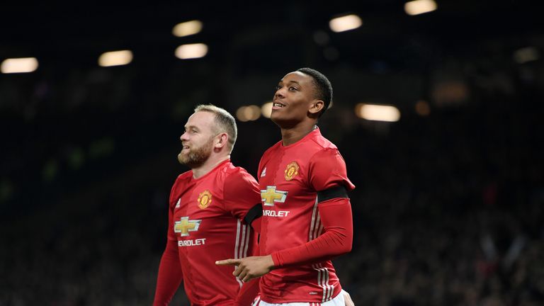 Anthony Martial of Manchester United celebrates with team mate Wayne Rooney