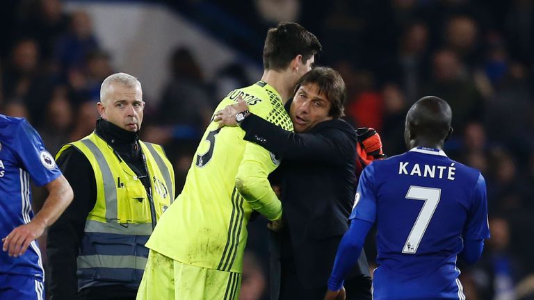 Chelsea's Thibaut Courtois (L) is hugged by head coach Antonio Conte