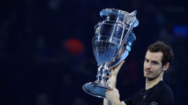 Andy Murray of Great Britain poses with the year end World number one trophy following his victory during the Singles