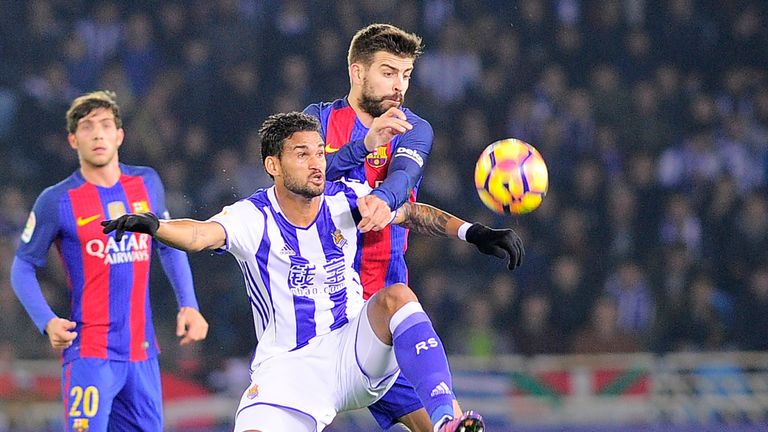 Real Sociedad's Brazilian forward Willian Jose (L) vies with Barcelona's defender Gerard Pique (R) during the Spanish league football match Real Sociedad v