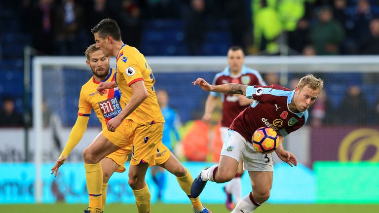 BURNLEY, ENGLAND - NOVEMBER 05:  Ben Mee of Burnley evades Yohan Cabaye and Martin Kelly of Crystal Palace during the Premier League match between Burnley 