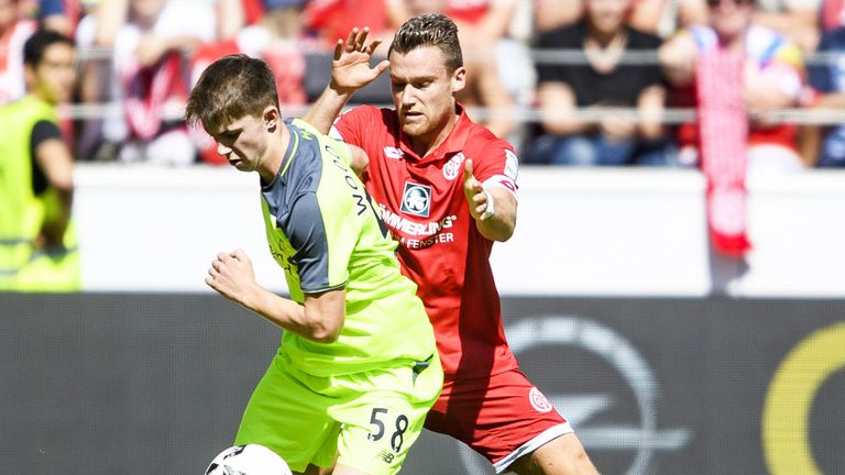 Liverpool teenage striker Ben Woodburn holds off a challenge