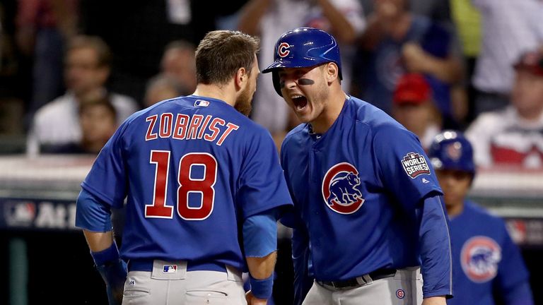 CLEVELAND, OH - NOVEMBER 01:  Ben Zobrist #18 of the Chicago Cubs celebrates with teammate Anthony Rizzo #44 after crashing into Roberto Perez #55 of the C