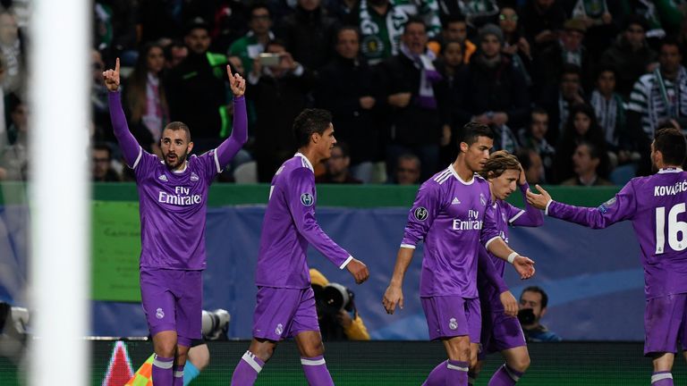 Real Madrid's French forward Karim Benzema (L) celebrates after scoring a goal during the UEFA Champions League football match Sporting CP vs Real Madrid C