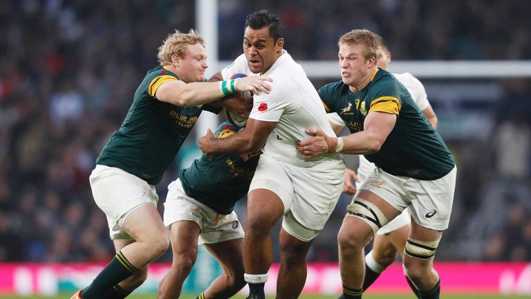 Billy Vunipola is tackled by Adrian Strauss (L) during the test match at Twickenham