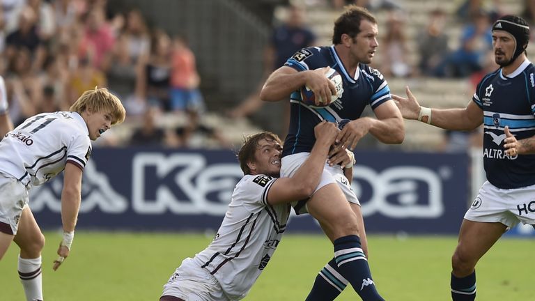 Montpellier's South African hooker Bismarck Du Plessis (R) is tackled by Bordeaux-Begles' South African lock Jandre Marais (L) during the French Top 14