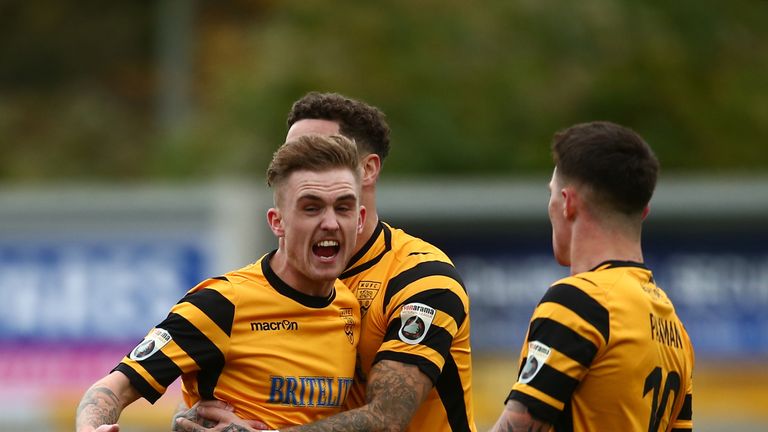 Bobby-Joe Taylor of Maidstone United (L) celebrates with team mates as he scores their first goal from the penalty spot