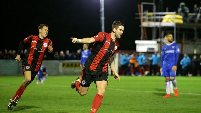 Brackley Town's James Armson celebrates scoring his sides fourth goal of the game during the FA Cup First Round Replay at St James Park, Brackley.