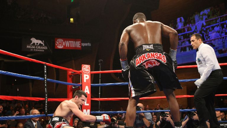 Jermain Taylor (R) stands over  Carl Froch after knocking him down during their WBC Super Middleweight Championship bout