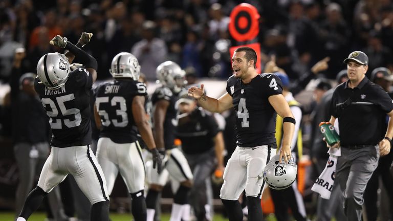 OAKLAND, CA - NOVEMBER 06:   Derek Carr #4 of the Oakland Raiders and D.J. Hayden #25 celebrate during the fourth quarter against the Denver Broncos at Oak