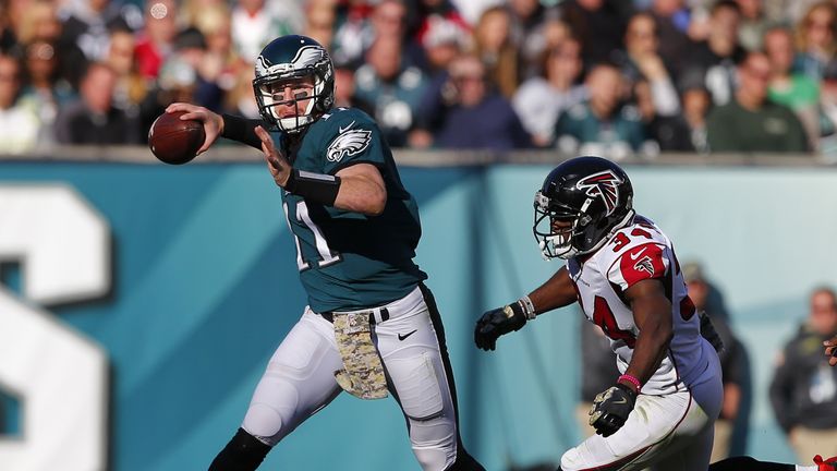 PHILADELPHIA, PA - NOVEMBER 13: Quarterback Carson Wentz #11 of the Philadelphia Eagles looks to throw on the run as Brian Poole #34 of the Atlanta Falcons