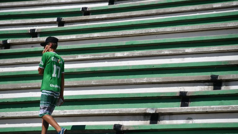 A young man walks on the stands before a tribute to the members of the Brazilian football team Chapecoense Real that were killed in a plane crash in the Co
