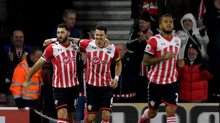 SOUTHAMPTON, ENGLAND - NOVEMBER 27: Charlie Austin of Southampton (L) celebrates scoring his sides first goal with Jose Fonte of Southampton (C) during the