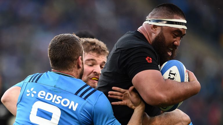 New Zealand's Charlie Faumuina runs with the ball against italy