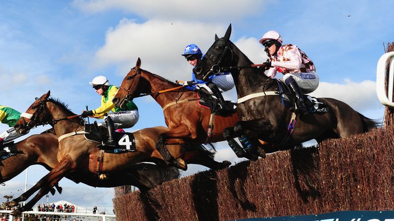 Un Beau Roman ridden by Nick Scholfield(R) jumps on their way to victory in the BetVictor Handicap Chase at Cheltenham