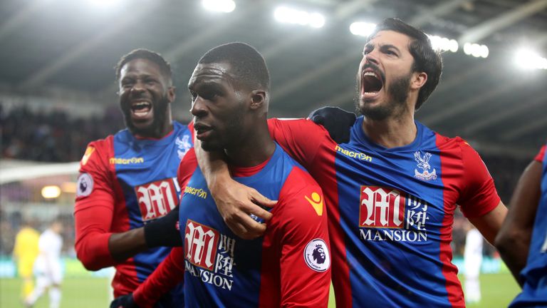 Crystal Palace's Christian Benteke celebrates scoring his sides fourth goal with team mates during the Premier League match at the Liberty Stadium, Swansea